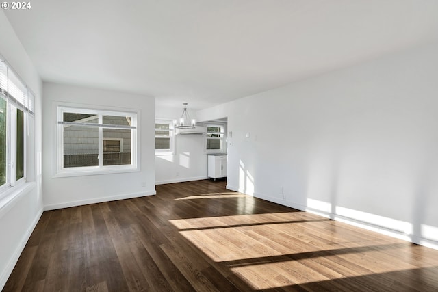 2746 Colorado St, Longview, WA 98632 - unfurnished living room with a chandelier, dark wood-type flooring, and plenty of natural light