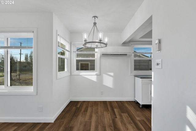 2746 Colorado St, Longview, WA 98632 - unfurnished dining area with a wall mounted air conditioner, a chandelier, dark wood finished floors, and baseboards