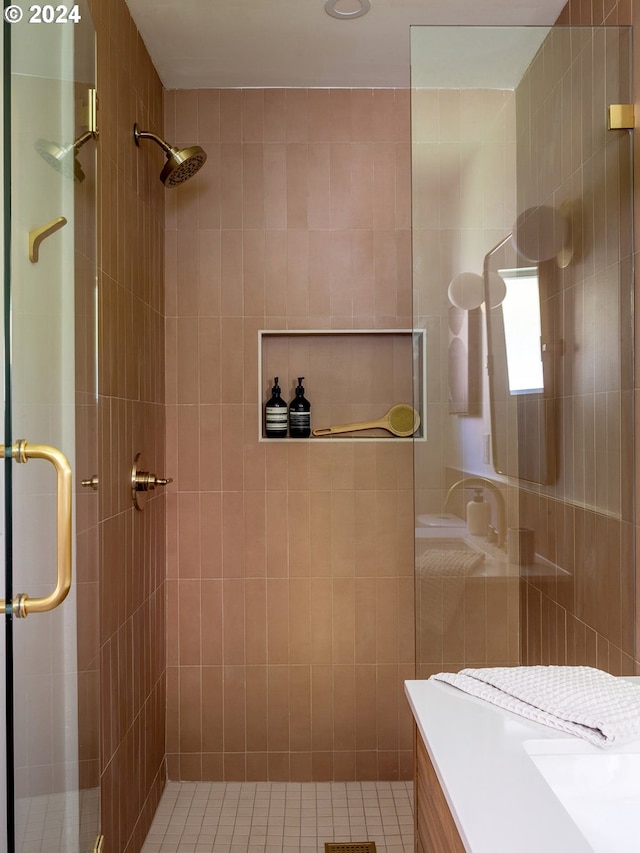 bathroom featuring tile walls, vanity, tile patterned floors, and a shower with door