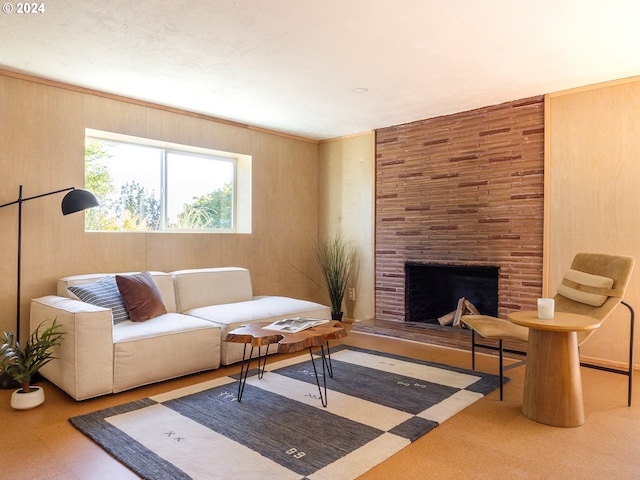 living room with wooden walls and a fireplace