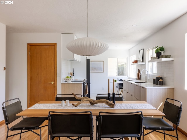 dining area featuring light hardwood / wood-style floors and sink