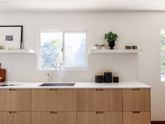 kitchen featuring tasteful backsplash and sink