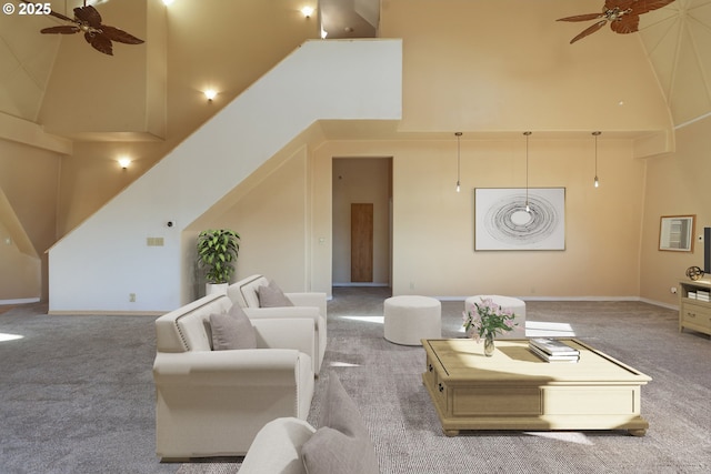 living room featuring ceiling fan and a high ceiling