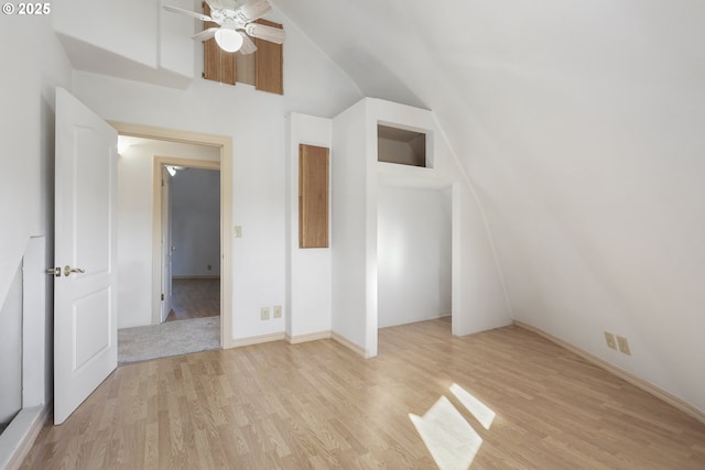 bonus room with light wood-type flooring, vaulted ceiling, and ceiling fan