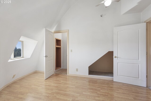 interior space featuring high vaulted ceiling, light hardwood / wood-style floors, and ceiling fan