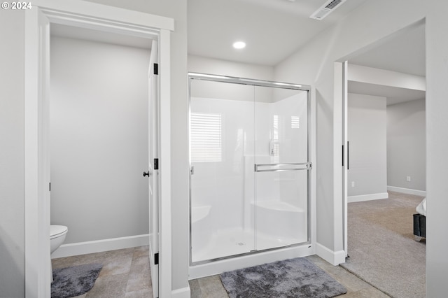 bathroom with walk in shower and toilet