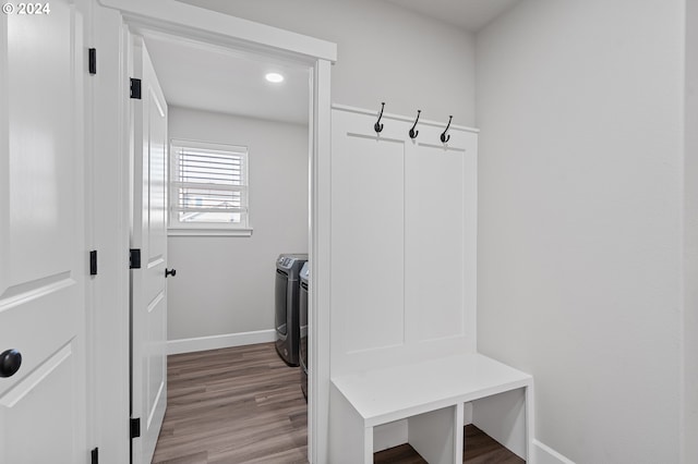 mudroom featuring washing machine and clothes dryer and hardwood / wood-style flooring