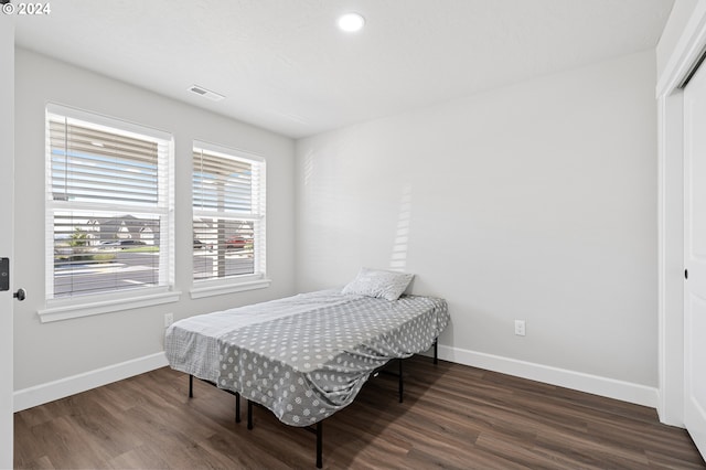 bedroom featuring a closet and dark hardwood / wood-style floors