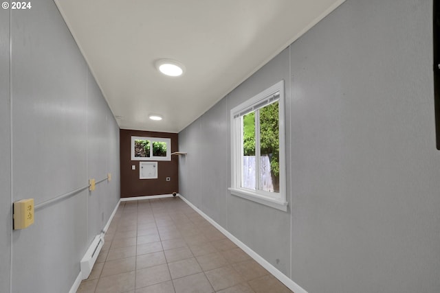 doorway with a baseboard heating unit and light tile patterned floors