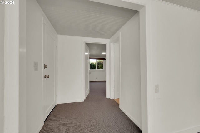 corridor with dark colored carpet