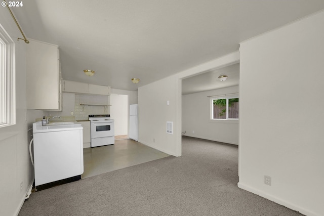 interior space featuring white cabinetry, white appliances, and sink