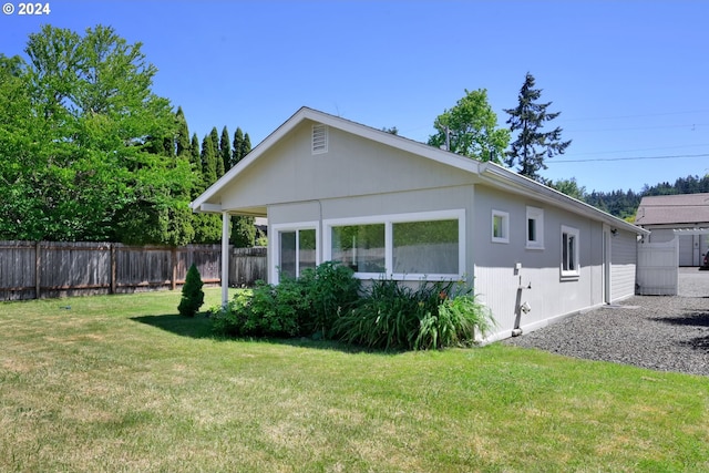 view of side of home featuring a lawn