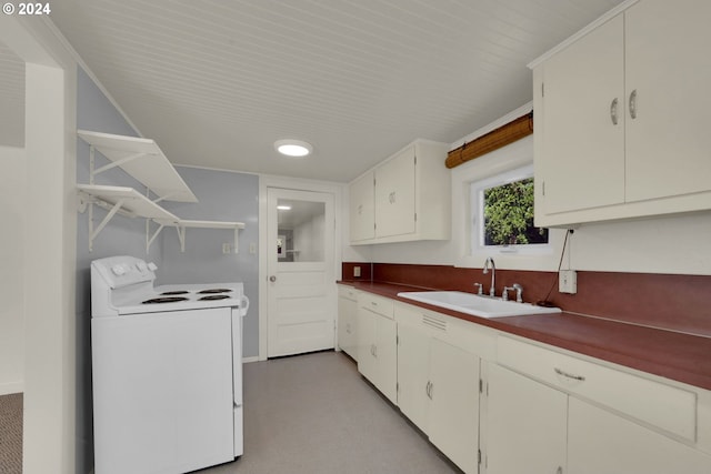 kitchen featuring sink, white electric stove, and white cabinets