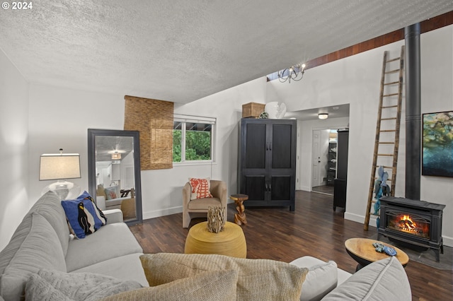 living room featuring a textured ceiling, a wood stove, and dark hardwood / wood-style floors