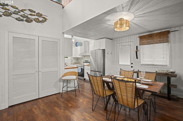 dining room with dark hardwood / wood-style flooring