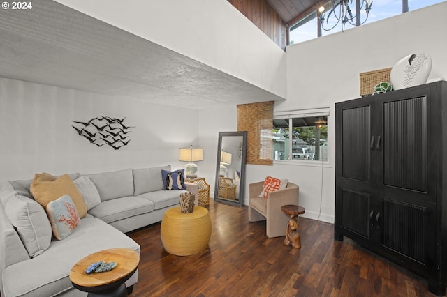 living room with dark hardwood / wood-style flooring and high vaulted ceiling