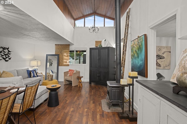 living room with dark hardwood / wood-style floors, a notable chandelier, a wood stove, lofted ceiling, and wooden ceiling