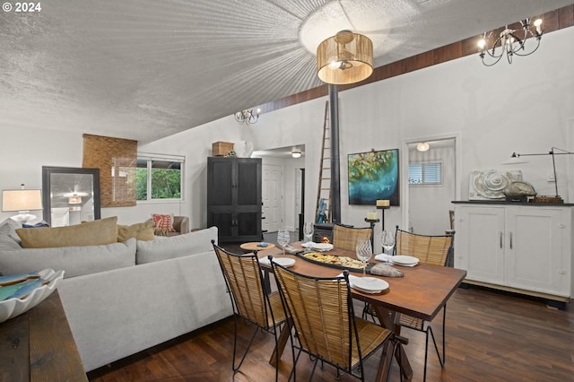 dining area featuring a textured ceiling, a chandelier, and dark hardwood / wood-style floors