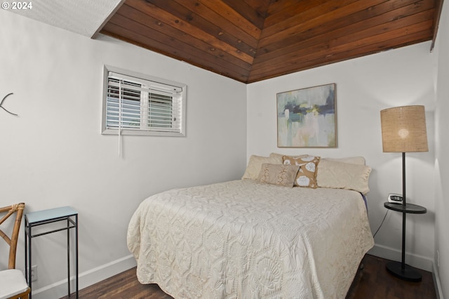 bedroom featuring dark hardwood / wood-style flooring, vaulted ceiling, and wood ceiling