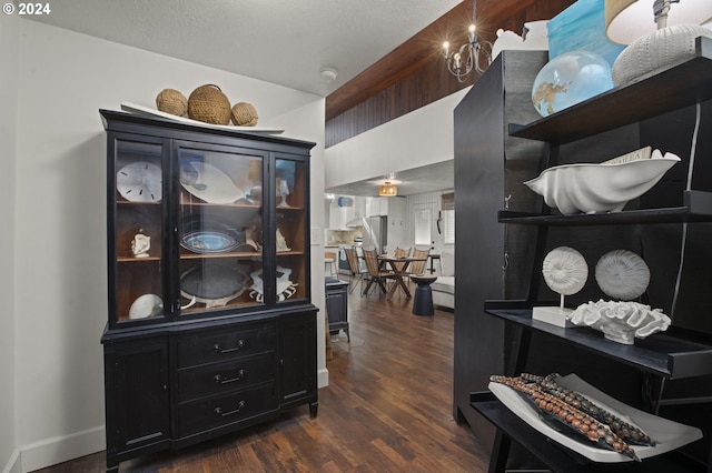 hallway with a textured ceiling and dark hardwood / wood-style floors