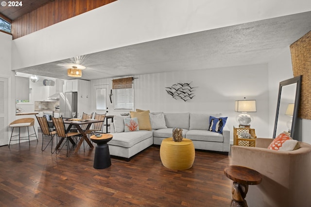 living room featuring a textured ceiling and dark hardwood / wood-style floors