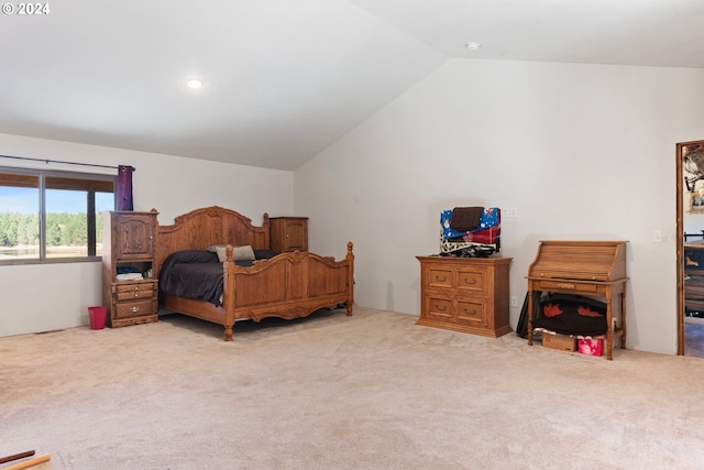 carpeted bedroom with vaulted ceiling