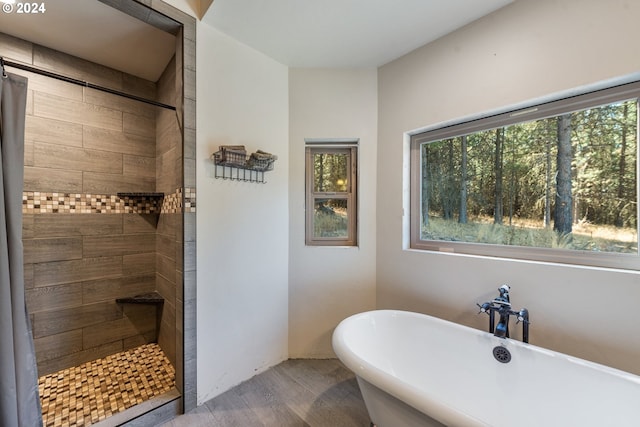 bathroom with hardwood / wood-style flooring and plus walk in shower