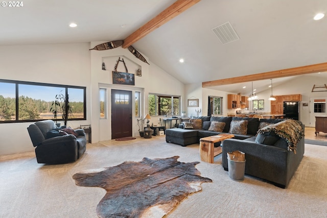 living room featuring light carpet, beamed ceiling, and high vaulted ceiling