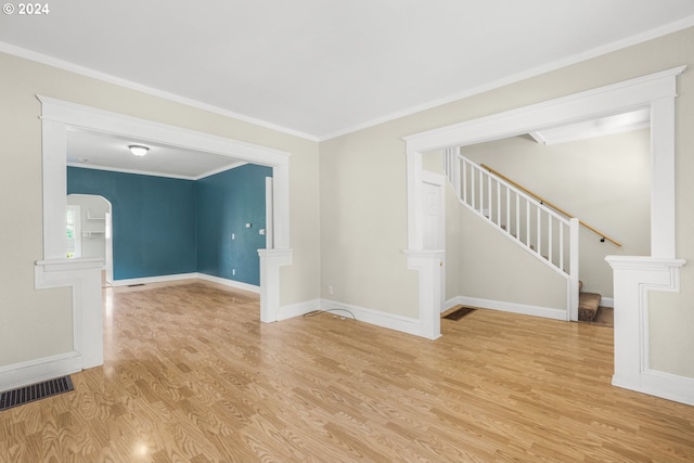 spare room with ornamental molding and light hardwood / wood-style floors