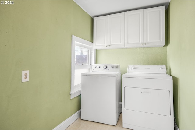 washroom with separate washer and dryer and cabinets