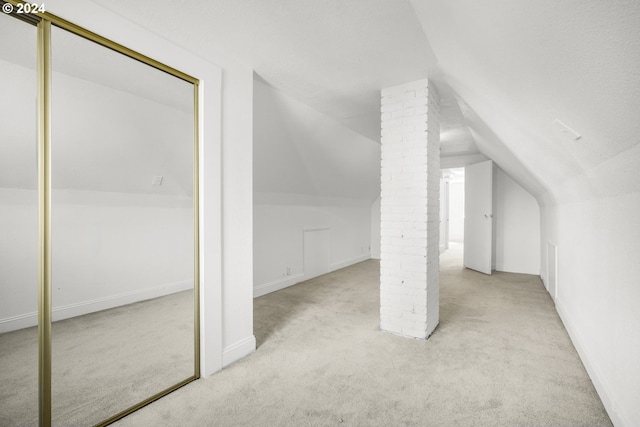 additional living space with light carpet and lofted ceiling