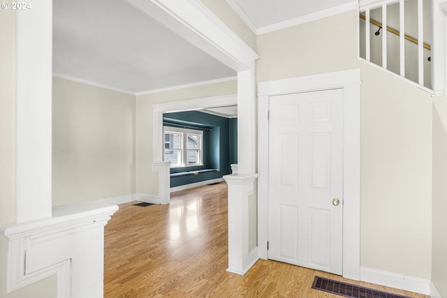 corridor with wood-type flooring and crown molding