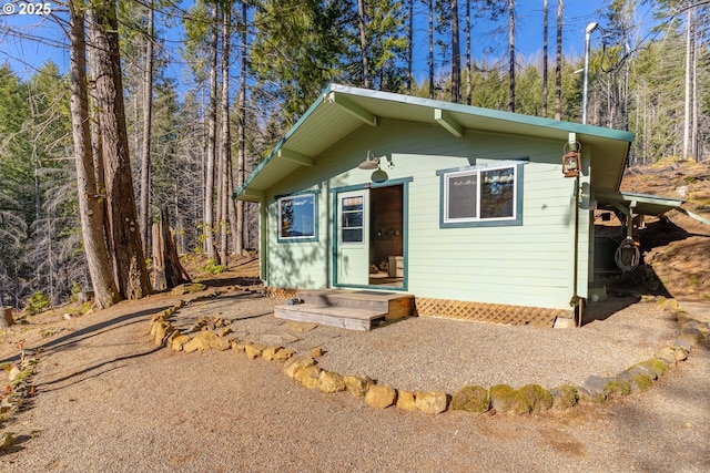 view of front of property with a view of trees