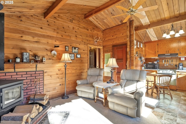 living room featuring vaulted ceiling with beams, wood ceiling, a wood stove, wood walls, and ceiling fan