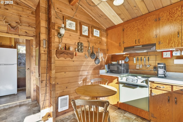 kitchen with electric range, wooden walls, freestanding refrigerator, under cabinet range hood, and black microwave