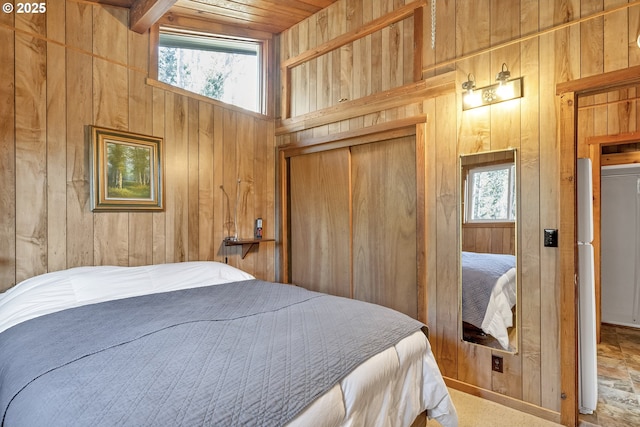 bedroom featuring wood walls