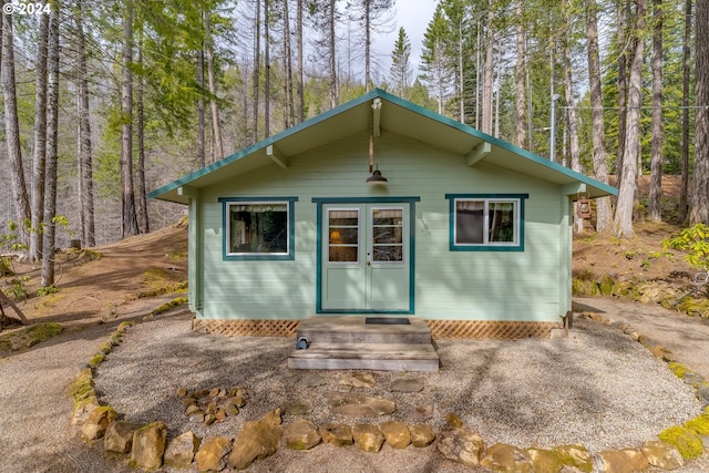 view of outbuilding featuring a view of trees