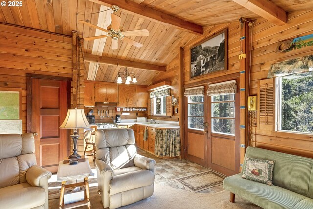 living area featuring vaulted ceiling with beams, wooden ceiling, wooden walls, a ceiling fan, and french doors