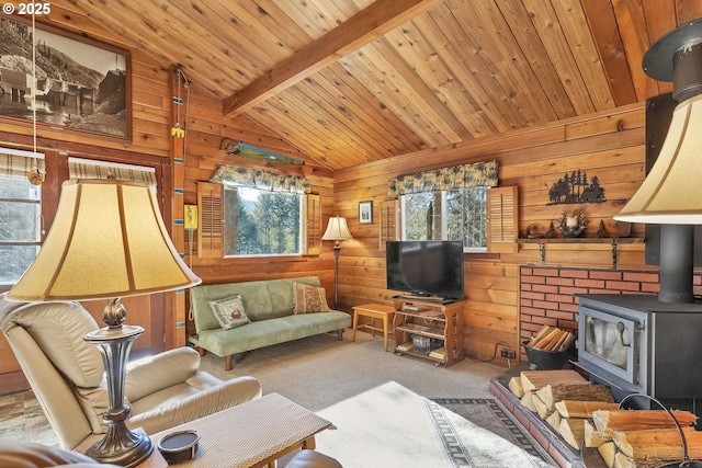 living area featuring lofted ceiling with beams, wood walls, wood ceiling, carpet, and a wood stove