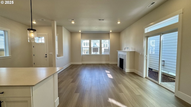 13910 SW 166th Ave, Tigard, OR 97223 - unfurnished living room with healthy amount of natural light, light wood-style floors, a fireplace, and recessed lighting