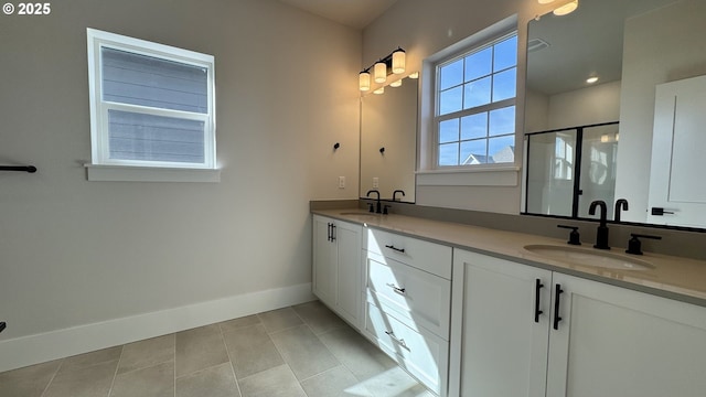 13910 SW 166th Ave, Tigard, OR 97223 - bathroom featuring double vanity, a shower stall, and tile patterned flooring