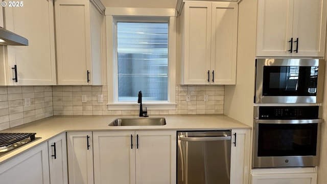 13910 SW 166th Ave, Tigard, OR 97223 - kitchen with appliances with stainless steel finishes, light countertops, decorative backsplash, and white cabinets