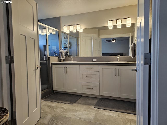 bathroom featuring an enclosed shower, vanity, and ceiling fan