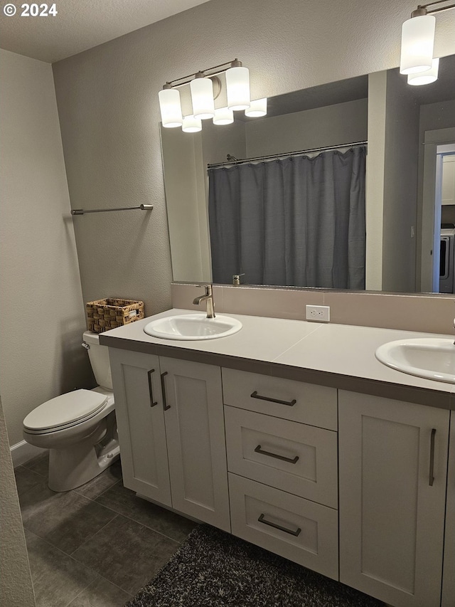 bathroom with curtained shower, vanity, and toilet