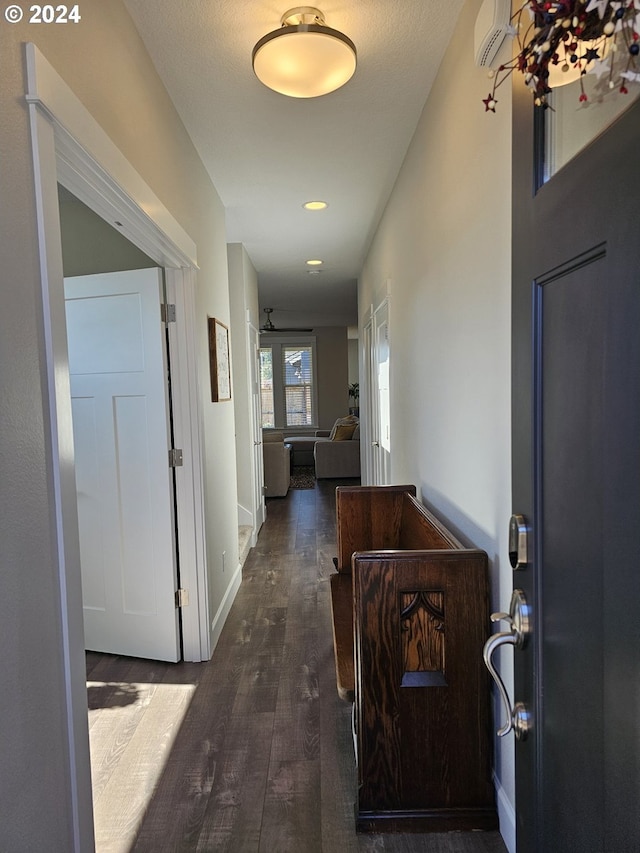 hall with dark hardwood / wood-style floors and a wall mounted AC