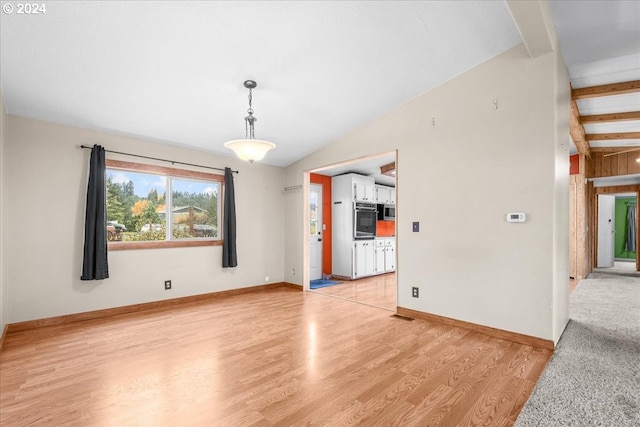 interior space with lofted ceiling and light wood-type flooring