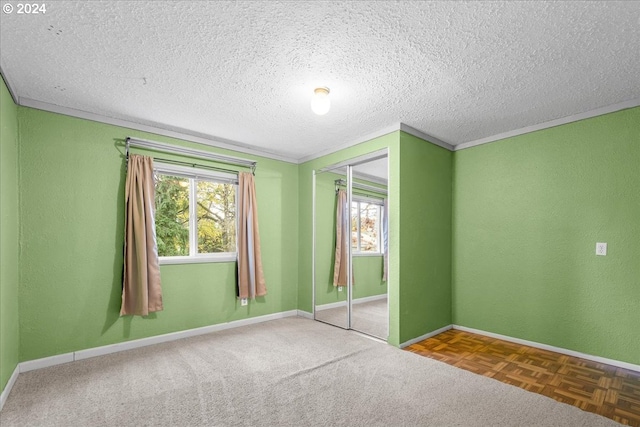 unfurnished bedroom with ornamental molding, a textured ceiling, and a closet