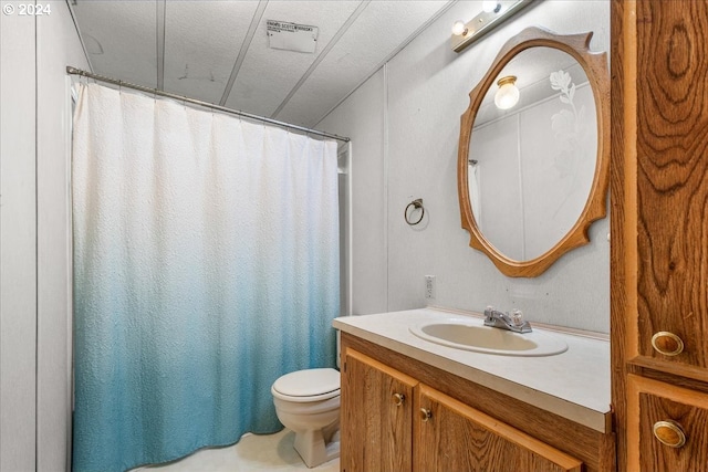 bathroom featuring toilet, vanity, and a textured ceiling