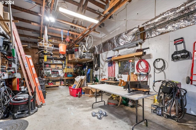 misc room with concrete floors and a workshop area