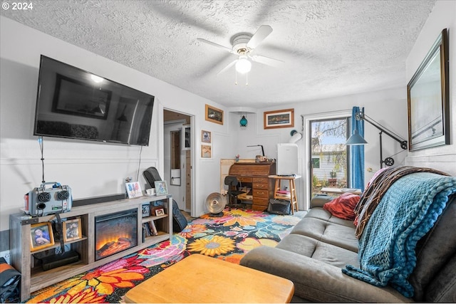 living room with a textured ceiling and ceiling fan